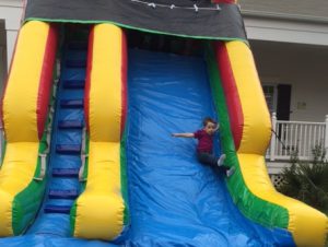 Kid sliding down inflatable slide