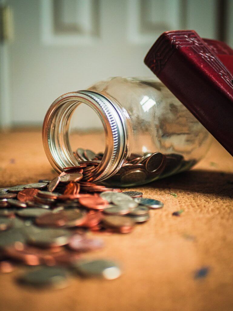 jar with coins spilling out