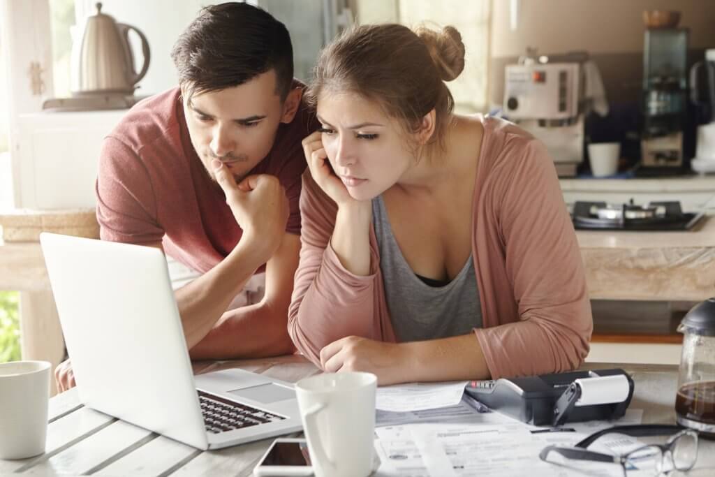 man and woman looking at laptop