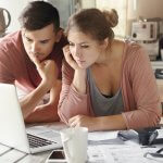 man and woman looking at laptop