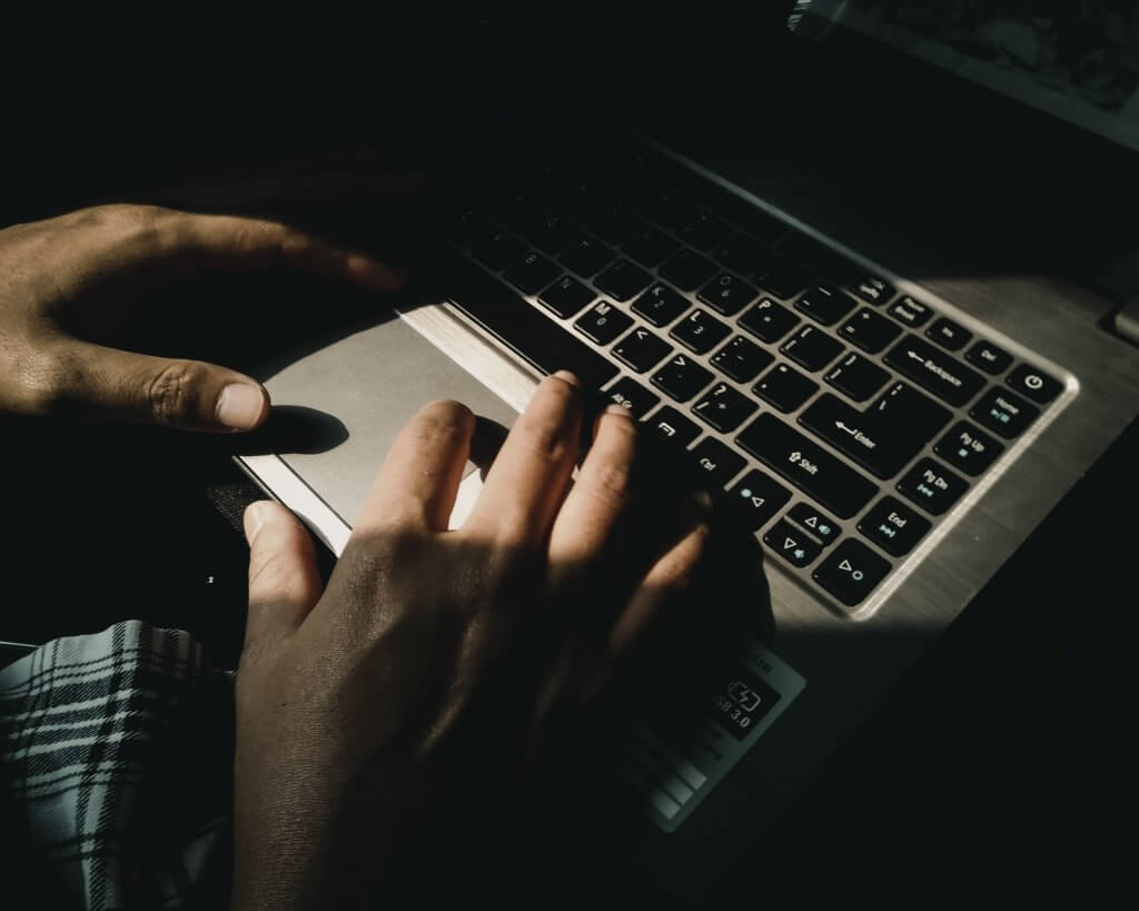 person typing on keyboard