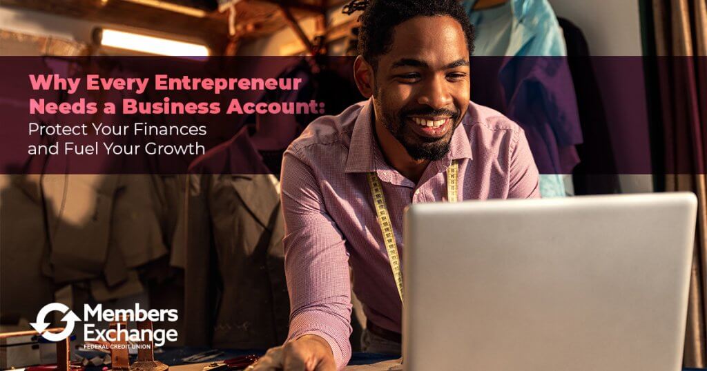 Smiling entrepreneur working on a laptop in a small business workspace.