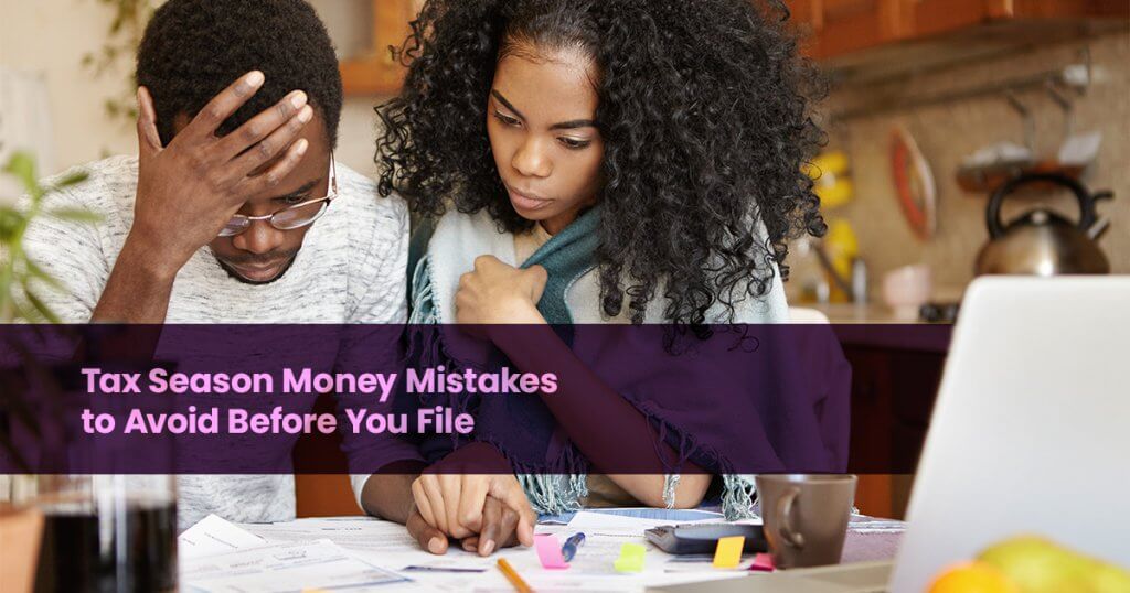 Couple reviewing bills and tax paperwork to avoid tax season money mistakes before filing