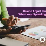 Person using a calculator to adjust a monthly budget as spending changes