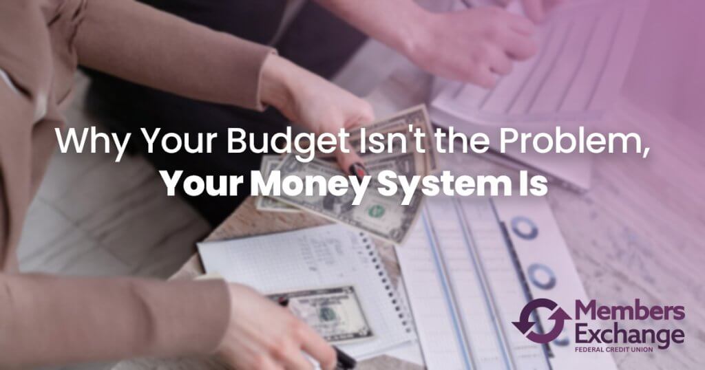 Person managing cash and reviewing a budget worksheet while creating a financial system for better money management and savings goals.
