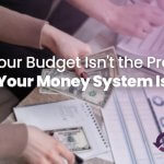 Person managing cash and reviewing a budget worksheet while creating a financial system for better money management and savings goals.